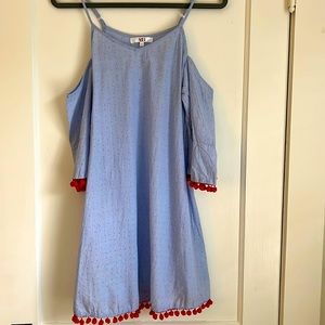 Blue slip dress with red pompoms